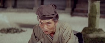 Movie still from “Kwaidan” (1964), directed by Masaki Kobayashi – An older man wearing a hat and a robe; Close Up shot, Low angle