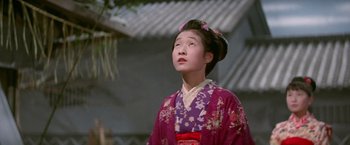 Movie still from “Kwaidan” (1964), directed by Masaki Kobayashi – A young woman in a kimono looking up at the sky; Close Up shot, Low angle