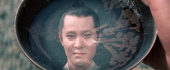 Movie still from “Kwaidan” (1964), directed by Masaki Kobayashi – A man with short black hair is looking at the camera; Close Up shot, High angle