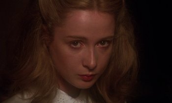 Movie still from “La Cage aux Folles” (1978), directed by Édouard Molinaro – A woman's face in a dark room; Close Up shot, High angle