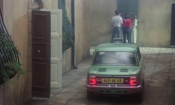 Movie still from “La Cage aux Folles” (1978), directed by Édouard Molinaro – A green car parked in a narrow alley way; Wide shot, High angle