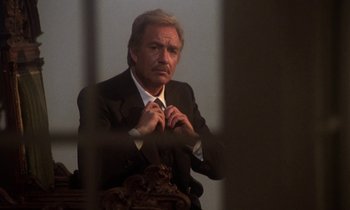 Movie still from “La Cage aux Folles” (1978), directed by Édouard Molinaro – An older man in a suit and a tie; Close Up shot, Low angle