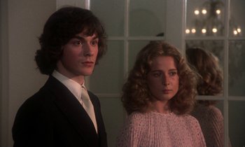 Movie still from “La Cage aux Folles” (1978), directed by Édouard Molinaro – A man and a woman standing next to each other; Medium shot, Low angle