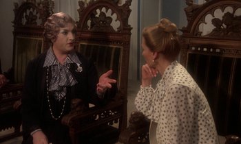 Movie still from “La Cage aux Folles” (1978), directed by Édouard Molinaro – A man and a woman are talking in a room; Medium shot, Over the shoulder angle