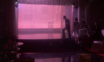 Movie still from “La Cage aux Folles” (1978), directed by Édouard Molinaro – A man and a woman standing in front of a stage; Wide shot, Low angle