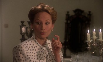 Movie still from “La Cage aux Folles” (1978), directed by Édouard Molinaro – An older woman in a white and black polka dot dress; Close Up shot, Over the shoulder angle