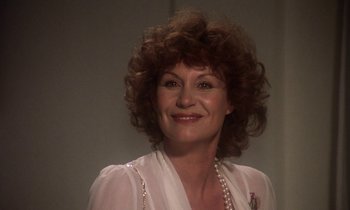 Movie still from “La Cage aux Folles” (1978), directed by Édouard Molinaro – A person wearing a white shirt; Close Up shot, Low angle