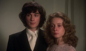 Movie still from “La Cage aux Folles” (1978), directed by Édouard Molinaro – A man and a woman standing next to each other; Close Up shot, Low angle