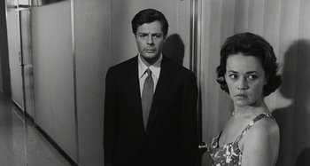 Movie still from “La Notte” (1961), directed by Michelangelo Antonioni – A black and white photo of a man and a woman; Medium shot, Low angle