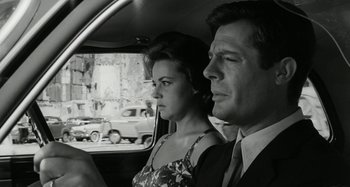 Movie still from “La Notte” (1961), directed by Michelangelo Antonioni – A man and a woman sitting in the back of a car; Close Up shot, Low angle