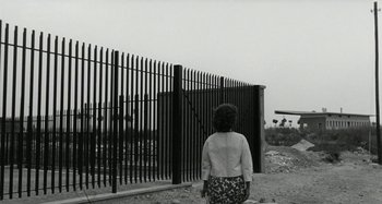 Movie still from “La Notte” (1961), directed by Michelangelo Antonioni – A woman standing in front of a metal fence; Wide shot, Low angle