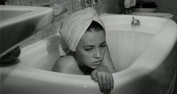Movie still from “La Notte” (1961), directed by Michelangelo Antonioni – A woman in a bath tub with a towel on her head; Close Up shot, High angle