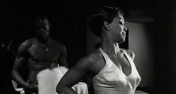 Movie still from “La Notte” (1961), directed by Michelangelo Antonioni – A black and white photo of a woman and a man; Medium shot, Over the shoulder angle