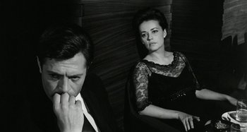 Movie still from “La Notte” (1961), directed by Michelangelo Antonioni – A man and a woman sitting next to each other; Medium shot, Low angle