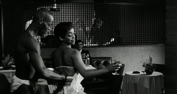 Movie still from “La Notte” (1961), directed by Michelangelo Antonioni – A black and white photo of a woman in a white dress; Medium shot, Low angle