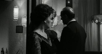 Movie still from “La Notte” (1961), directed by Michelangelo Antonioni – A man and a woman standing next to each other; Medium shot, Over the shoulder angle