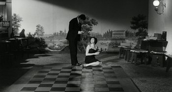 Movie still from “La Notte” (1961), directed by Michelangelo Antonioni – A man and a woman are standing on the floor; Wide shot, High angle