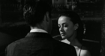 Movie still from “La Notte” (1961), directed by Michelangelo Antonioni – A man and a woman standing next to each other; Close Up shot, Over the shoulder angle