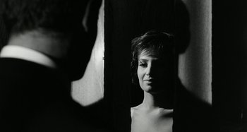 Movie still from “La Notte” (1961), directed by Michelangelo Antonioni – A woman is looking at herself in the mirror; Close Up shot, Over the shoulder angle