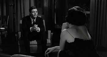 Movie still from “La Notte” (1961), directed by Michelangelo Antonioni – A black and white photo of a man and a woman; Medium shot, Over the shoulder angle