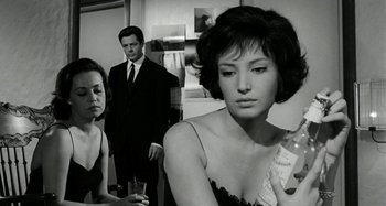 Movie still from “La Notte” (1961), directed by Michelangelo Antonioni – A man and a woman standing next to each other in a room; Medium shot, Low angle
