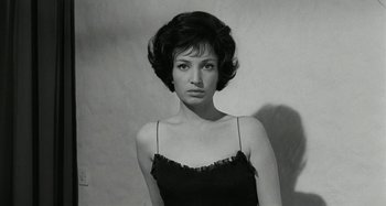 Movie still from “La Notte” (1961), directed by Michelangelo Antonioni – A black and white photo of a woman in a black dress; Close Up shot, Low angle