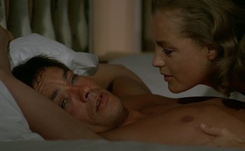 Movie still from “The Swimming Pool” (1969), directed by Jacques Deray – A man and a woman laying in a bed; Close Up shot, High angle