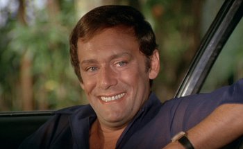 Movie still from “The Swimming Pool” (1969), directed by Jacques Deray – A person sitting in a car; Close Up shot, Low angle