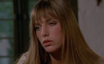 Movie still from “The Swimming Pool” (1969), directed by Jacques Deray – A person with long brown hair; Close Up shot, Low angle