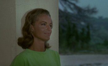Movie still from “The Swimming Pool” (1969), directed by Jacques Deray – A woman in a green shirt is looking up; Close Up shot, Over the shoulder angle