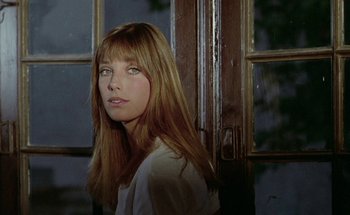 Movie still from “The Swimming Pool” (1969), directed by Jacques Deray – A beautiful woman with long red hair standing in front of a door; Close Up shot, Low angle