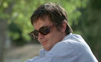 Movie still from “The Swimming Pool” (1969), directed by Jacques Deray – A person wearing sunglasses; Close Up shot, Low angle