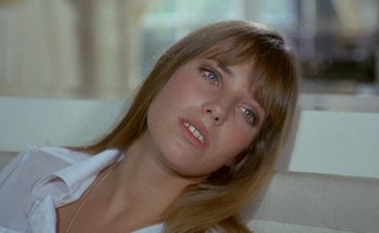 Movie still from “The Swimming Pool” (1969), directed by Jacques Deray – A person wearing a white shirt; Close Up shot, High angle