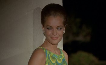 Movie still from “The Swimming Pool” (1969), directed by Jacques Deray – A young woman in a green dress smiling for the camera; Close Up shot, Low angle