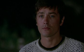 Movie still from “The Swimming Pool” (1969), directed by Jacques Deray – A person wearing a sweater; Close Up shot, Low angle