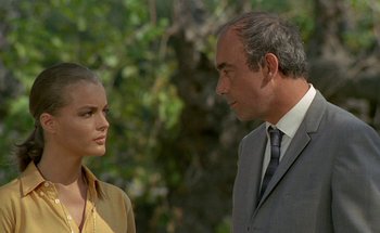 Movie still from “The Swimming Pool” (1969), directed by Jacques Deray – A man and a woman talking to each other; Medium shot, Low angle