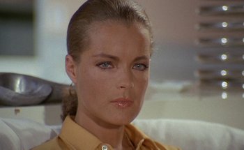 Movie still from “The Swimming Pool” (1969), directed by Jacques Deray – A person wearing a yellow shirt; Close Up shot, High angle