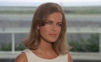 Movie still from “The Swimming Pool” (1969), directed by Jacques Deray – A beautiful woman with long brown hair wearing a white top; Close Up shot, Low angle