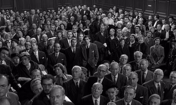 Movie still from “The Truth” (1960), directed by Henri-Georges Clouzot – A group of people in suits and ties in front of a crowd; Wide shot, High angle