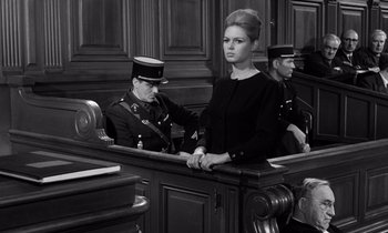 Movie still from “The Truth” (1960), directed by Henri-Georges Clouzot – A man and a woman sitting in a court room; Medium shot, Low angle