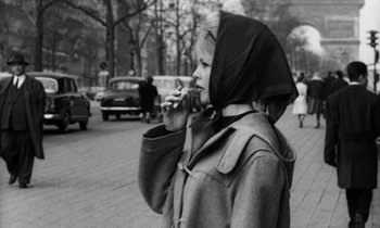 Movie still from “The Truth” (1960), directed by Henri-Georges Clouzot – A woman in a hooded jacket talking on a phone; Close Up shot, Low angle