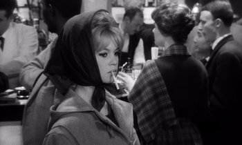 Movie still from “The Truth” (1960), directed by Henri-Georges Clouzot – A black and white photo of a woman smoking a cigarette; Close Up shot, Over the shoulder angle
