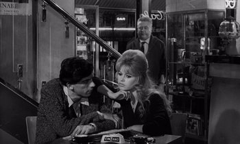 Movie still from “The Truth” (1960), directed by Henri-Georges Clouzot – A man and a woman sitting at a table in a restaurant; Medium shot, High angle