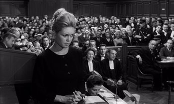 Movie still from “The Truth” (1960), directed by Henri-Georges Clouzot – A woman in a black dress is in a court room; Medium shot, Low angle