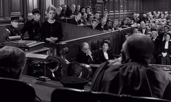 Movie still from “The Truth” (1960), directed by Henri-Georges Clouzot – A group of people sitting in a court room; Medium shot, High angle