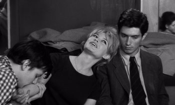 Movie still from “The Truth” (1960), directed by Henri-Georges Clouzot – A man and a woman sitting next to each other on a couch; Medium shot, High angle