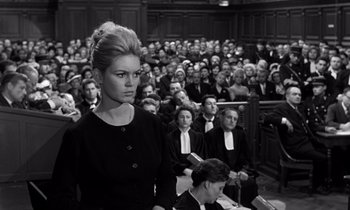 Movie still from “The Truth” (1960), directed by Henri-Georges Clouzot – A woman standing in front of a crowd in a courtroom; Medium shot, High angle