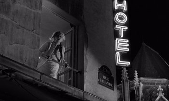 Movie still from “The Truth” (1960), directed by Henri-Georges Clouzot – A woman standing on a balcony of an old hotel; Wide shot, Low angle