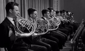 Movie still from “The Truth” (1960), directed by Henri-Georges Clouzot – A group of men sitting next to each other holding instruments; Medium shot, Low angle