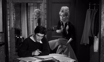 Movie still from “The Truth” (1960), directed by Henri-Georges Clouzot – A man and a woman sitting at a table with papers on it; Medium shot, High angle
